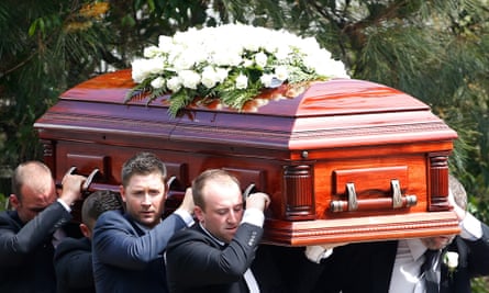 Michael Clarke, third left, helps carry the coffin of Phillip Hughes.