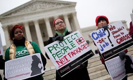 Protesters gather outside the US supreme Court while the court hears arguments in the Young v UPS case December 3, 2014 in Washington.