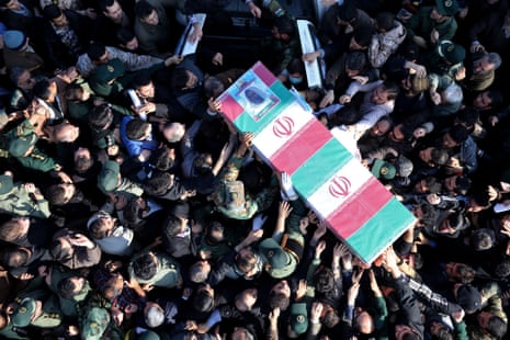 Iranian civilians and members of its armed forces carry the flag draped coffin of Brigadier General  Hamid Taqavi, a senior Revolutionary Guard commander, who was killed during a battle against Isis.