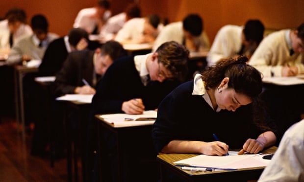 Schoolboys and girls sitting GCSE exams.