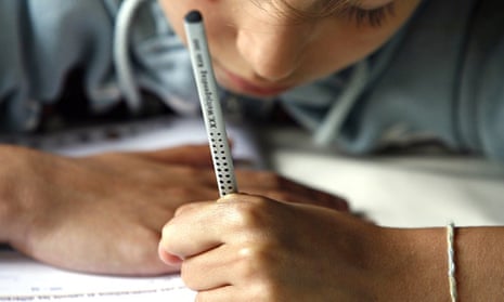 Left-handed girl writing in a schoolbook