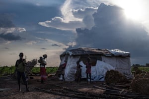 Martha Nyarueni (2ndL) and her family stand outside their home outside the town of Leer, South Sudan, after receiving aid package, on July 5, 2014. 