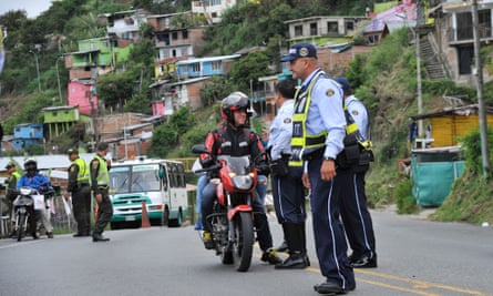 Police officers stop traffic in the shantytown of Terron Colorado in Cali, Colombia