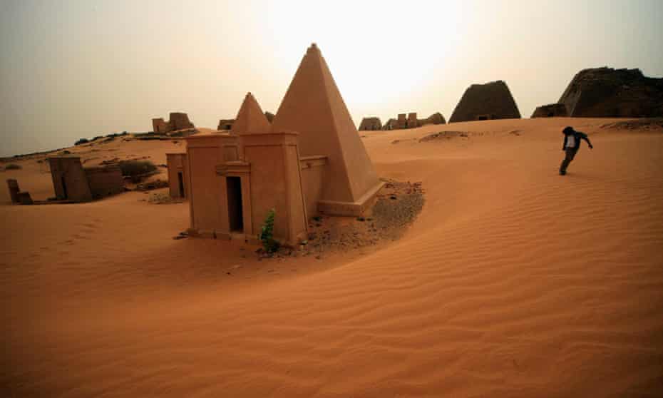 A boy plays near the site of 44 Nubian pyramids of kings and queens in the ruins of the ancient city of Meroe at Begrawiya in Sudan