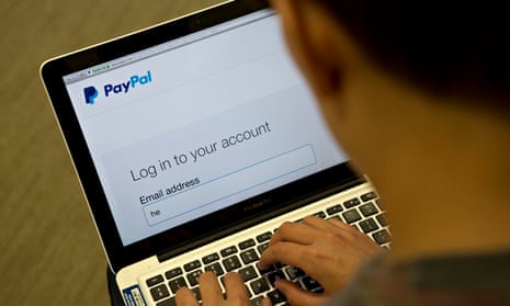 Male on laptop looking at Paypal