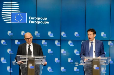 (L-R) European Commissioner for economics, taxation and customs Pierre Moscovici and Eurogroup president Jeroen Dijsselbloem attend a press conference after an Euro zone finance ministers meeting in Brussels December 8, 2014.