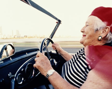 Older woman driving convertible sportscar