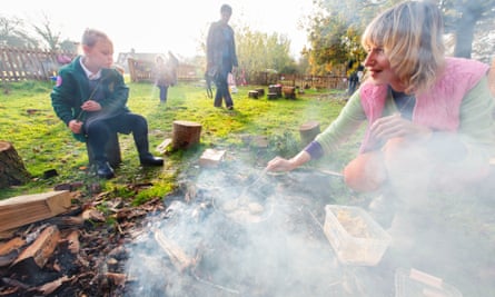 Emma Harwood and Tilly, 5, making Welsh cakes on an open fire at Dandelion forest school.