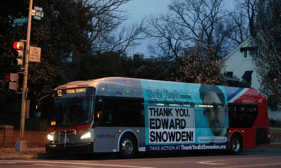 A Washington Metro bus with an Edward Snowden sign on its side panel.