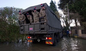 Soldiers travel in a truck as they aid relief efforts in the flooded village of Wraysbury.
