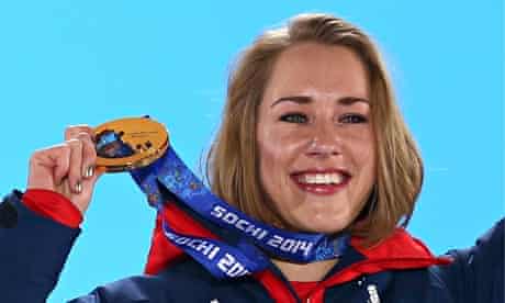 Lizzy Yarnold celebrates on the podium with her Winter Olympic gold medal