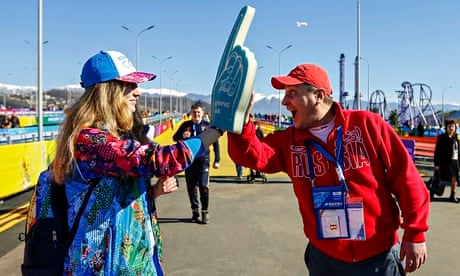 Volunteer Yuliya Udalykh is greeted by a fan at the Olympic Park in Sochi