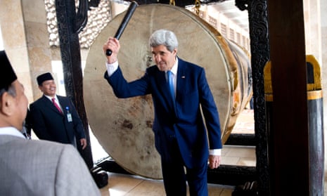 Secretary of State John Kerry raises his hand after beating the call to prayer drum.