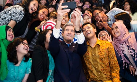 Secretary of State John Kerry takes a selfie with a group of students before delivering a speech on climate change in Jakarta.