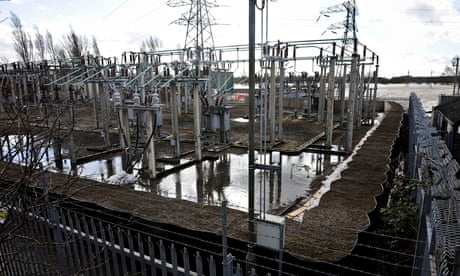 Sandbags around an electricity substation close to the flooded river Severn in Gloucester