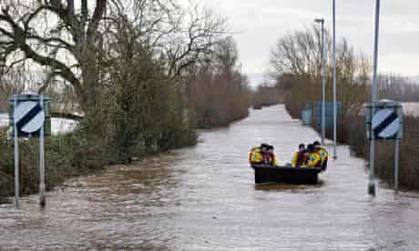 A police patrol boat floats down the flooded A361 in the Somerset Levels.
