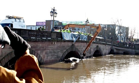 Engineers work to clear debris from the river Severn at Worcester bridge 