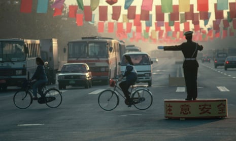 Beijing Traffic Policeman stands on a podium in the middle of the road directing traffic ca. October 1991 Beijing, China
