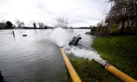 Water being pumped out of houses near the river Thames at Chertsey, Surrey