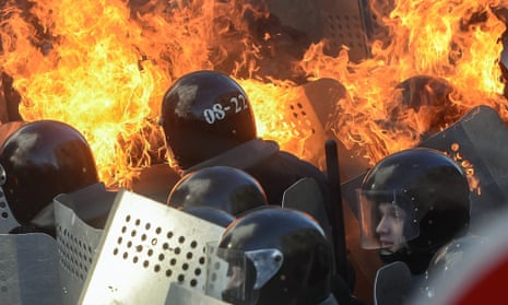 Riot policemen in flames clash with protesters in downtown Kiev.