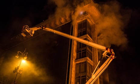 A fire truck is used to rescue people from the upper floors of a burning Trade Unions Building, which has been used as the de facto headquarters for anti-government protesters, on February 19, 2014 in Kiev, Ukraine.