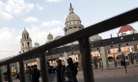 Mexican federal police stand guard outside the San Jose Cathedral in Toluca, Mexico.