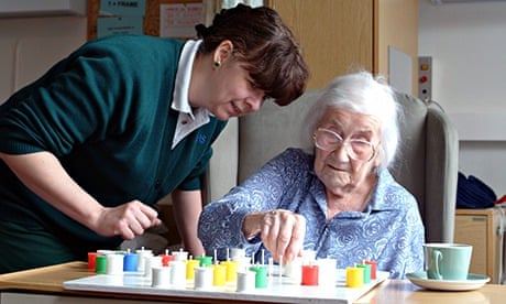 Woman plays solitaire with nurse