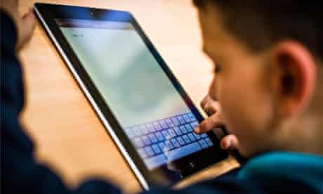 Child using Apple iPad tablet 