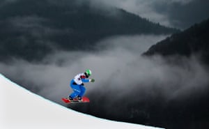 Hanno Douschan of Austria competes in the quarter finals in the men's snowboard cross