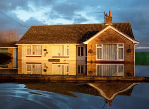A home in Moorland is reflected in the still flood waters.