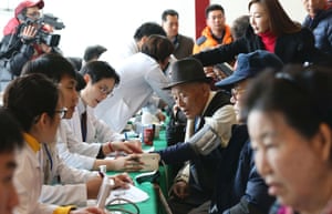 Elderly, frail South Koreans receive medical checks as they arrive in Sokcho to take part in the reunions