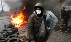 Anti-government protesters man a barricade in central Kiev, Ukraine, Thursday, Feb. 20, 2014