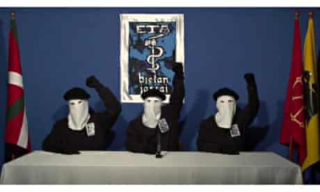 Eta members give a salute following a news conference at an unknown location in October 2011