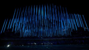Performers hold up representations of birds as blue lights fill the stadium during the closing ceremony for the Sochi 2014 Winter Olympic Games.