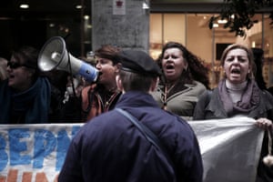 Laid-off members of the cleaning staff at the Finance ministry shout slogans during a protest outside the ministry in Athens during the visit of the so-called troika creditors in Athens on February 24, 2014.