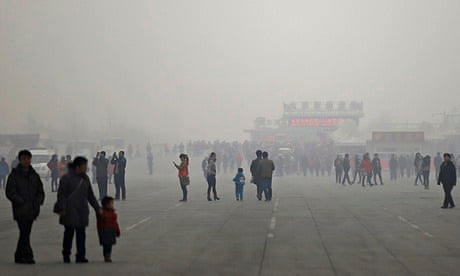 People visit the Olympic Park amid thick haze in Beijing