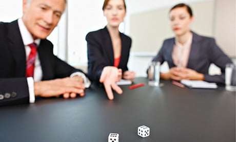 Business people throwing dice on conference room table. Image shot 2009. Exact date unknown.