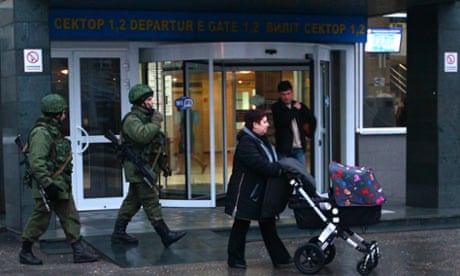Armed men patrol at the airport in Simferopol, Crimea on 28 February, 2014.