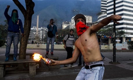 A demonstrator throws an incendiary device during clashes with Venezuelan National Bolivarian Guard (GNB) during a protest against president Nicolas Maduro in Caracas, Venezuela. The Venezuelan government accuses the opposition of attempting a coup d'etat to topple President Nicolas Maduro, who narrowly won election last year as the hand-picked successor to left-wing populist Hugo Chavez, who died in office March 2013.