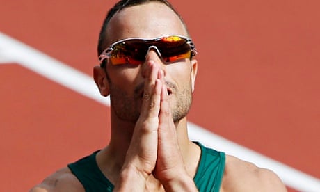Oscar Pistorius on track at London Olympics, hands together as if in prayer, he looks at scoreboard