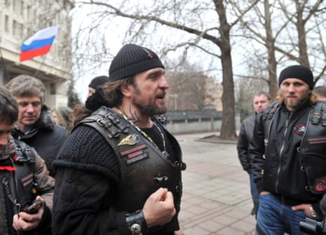 Alexander Zaldostanov (C), nicknamed "the Surgeon", leader of a group of Russian bikers called the Night Wolves, attends a rally of pro-Russian activists waving the Russian flag, in front of the local parliament building on February 28, 2014 in Simferopol, Crimea.