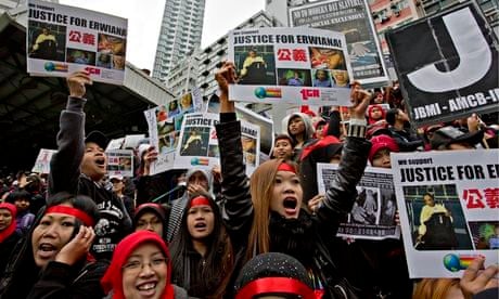 Domestic workers shout slogans during a protest in Hong Kong