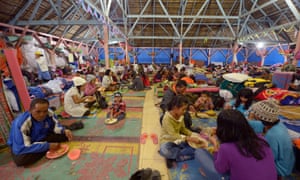 Villagers have dinner at a temporary shelter in Karo