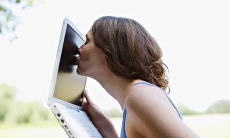 Woman kissing a computer