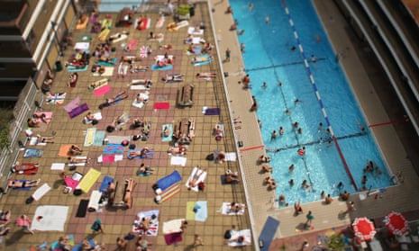 Swimmers enjoy the sunshine at an outdoor pool in central London in a heatwave in summer 2013