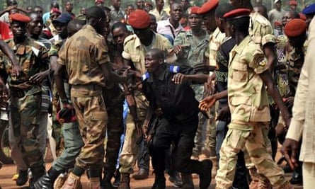 Members of the Central African Armed Forces surround a gendarme