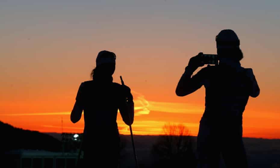 Athletes take pictures during a biathlon training session ahead of the Sochi 2014 Winter Olympics at the Laura Cross-Country Ski and Biathlon Center on February 6, 2014 in Sochi, Russia. The make of phone isn't clear.