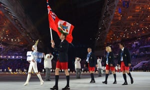 Bermuda's flag bearer, cross-country skier Tucker Murphy, leads his national delegation during the Opening Ceremony of the Sochi Winter Olympics.