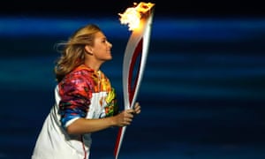 Russian tennis player Maria Sharapova carries the Olympic torch during the opening ceremony of the 2014 Winter Olympics.