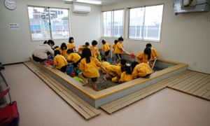 Children play at an indoor sand pit of the Emporium kindergarten in Koriyama.